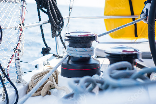 Sailing yacht ropes and winch. Sailboat equipment details. Water transport, marine travel lifestyle vacation theme.
