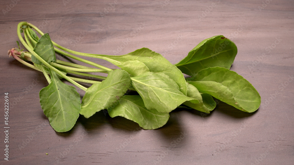 Bundle of fresh spinach isolated on wooden background. Vegan food lifestyle concept, Copy space. Bundle of fresh spinach isolated on wooden background. Vegan food lifestyle concept, Copy space.