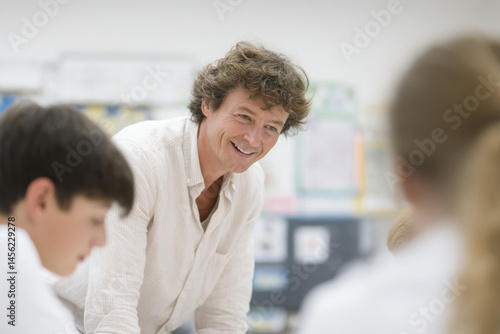 classroom scene where teacher provides constructive feedback to students showcasing engagement and collaboration