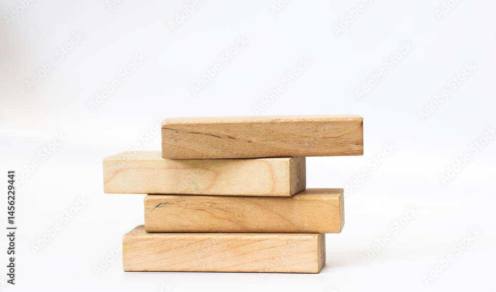 A pile of four wooden blocks on the soft white background. A pile of four wooden blocks on the soft white background.