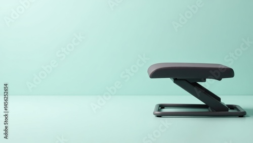 Under Desk Foot Rest. Invisible Support Station. Isolated background, copyspace.. Humble footrest offers discreet support and comfort, symbolizing unassuming reliability in quiet corner of home.