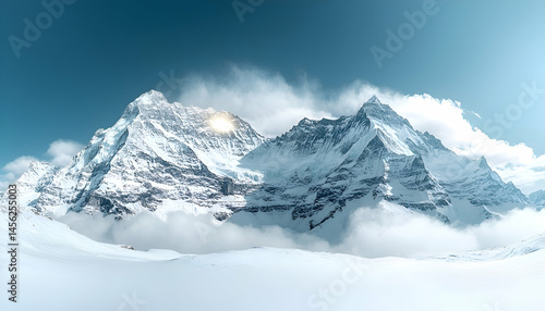 Snowy Mountain Peaks with Clouds and Sunlight