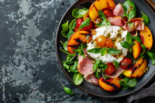 Obraz na płótnie A gourmet breakfast plate with sunny side up eggs, prosciutto, peaches, and fresh greens on a dark slate background. w salonie