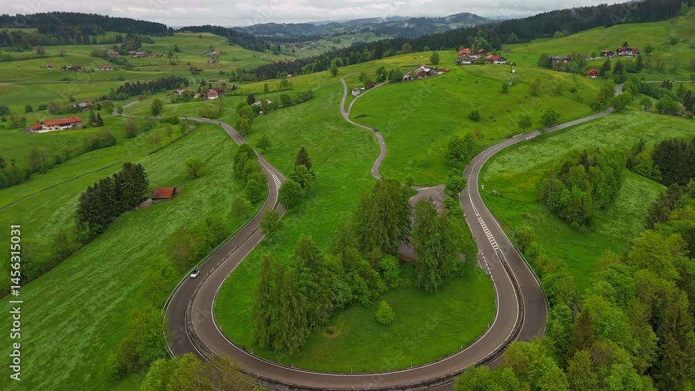 Cars moving on a scenic Bavarian road among hills Cars moving on a scenic Bavarian road among hills