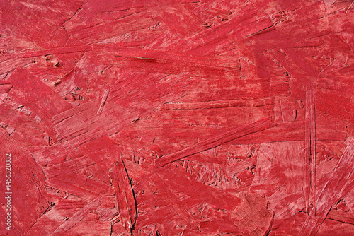 Obraz na płótnie A close-up shows a textured red painted oriented strand board surface w salonie