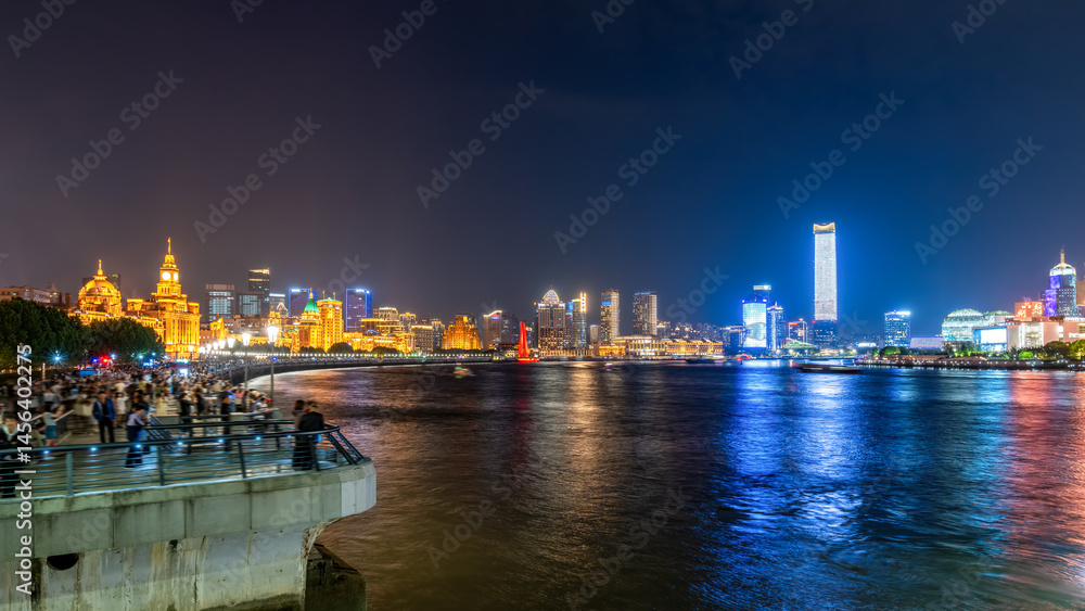 Fototapeta premium Captivating Night View of a Vibrant City Skyline Illuminated by Colorful Lights