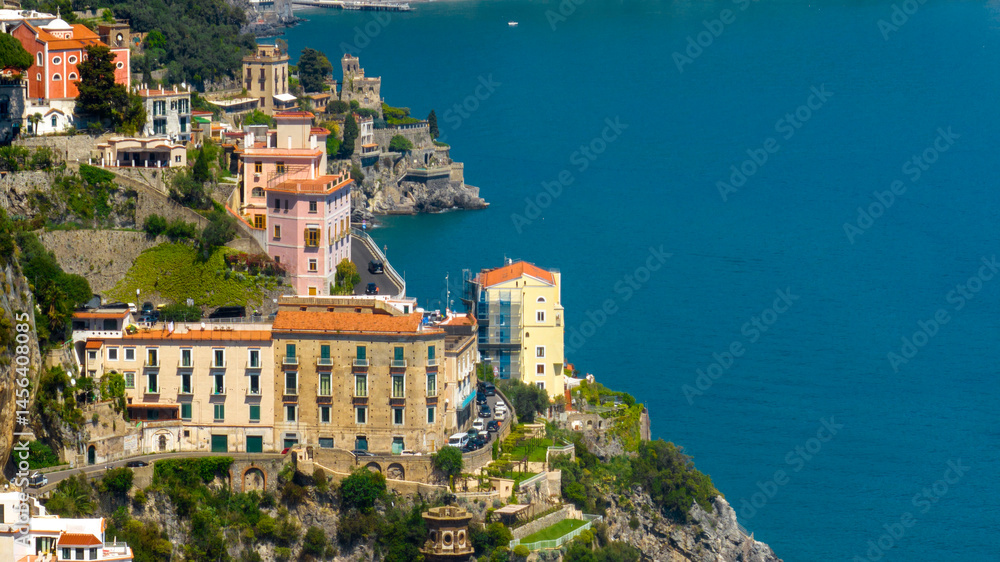 Naklejka premium Aerial view of beautiful houses and apartments overlooking the sea in the Amalfi Coast. It is a stretch of coast on the Gulf of Salerno, in Campania region, Italy.