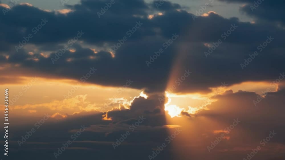 Dramatic clouds at sunset with rays of sunlight breaking through. Nature and atmospheric concept. Dramatic clouds at sunset with rays of sunlight breaking through. Nature and atmospheric concept.