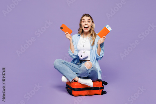 Εκτύπωση καμβά Traveler woman wear blue clothes sit on bag use mobile cell phone hold ticket is