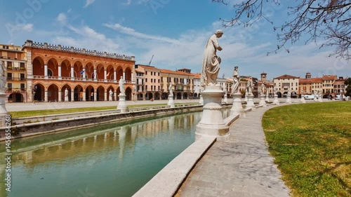 Prato della Valle Square presents an expansive plaza framed by classical colonnades and open greenery, Padua, Veneto, Italy