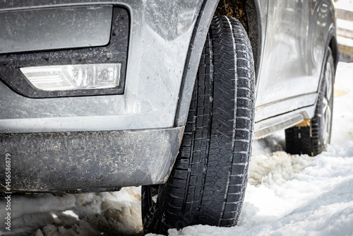 Front of the car with headlight, side view.