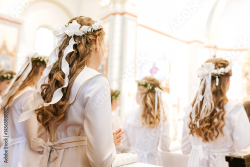 Beautiful Communion Hairstyle with Green Leaf Wreath on Girl During Holy Mass