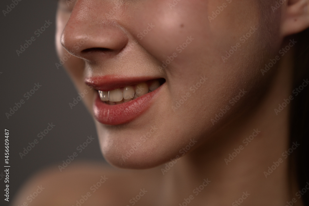 Fototapeta premium Close Up of a Woman Smiling with Bright Red Lipstick