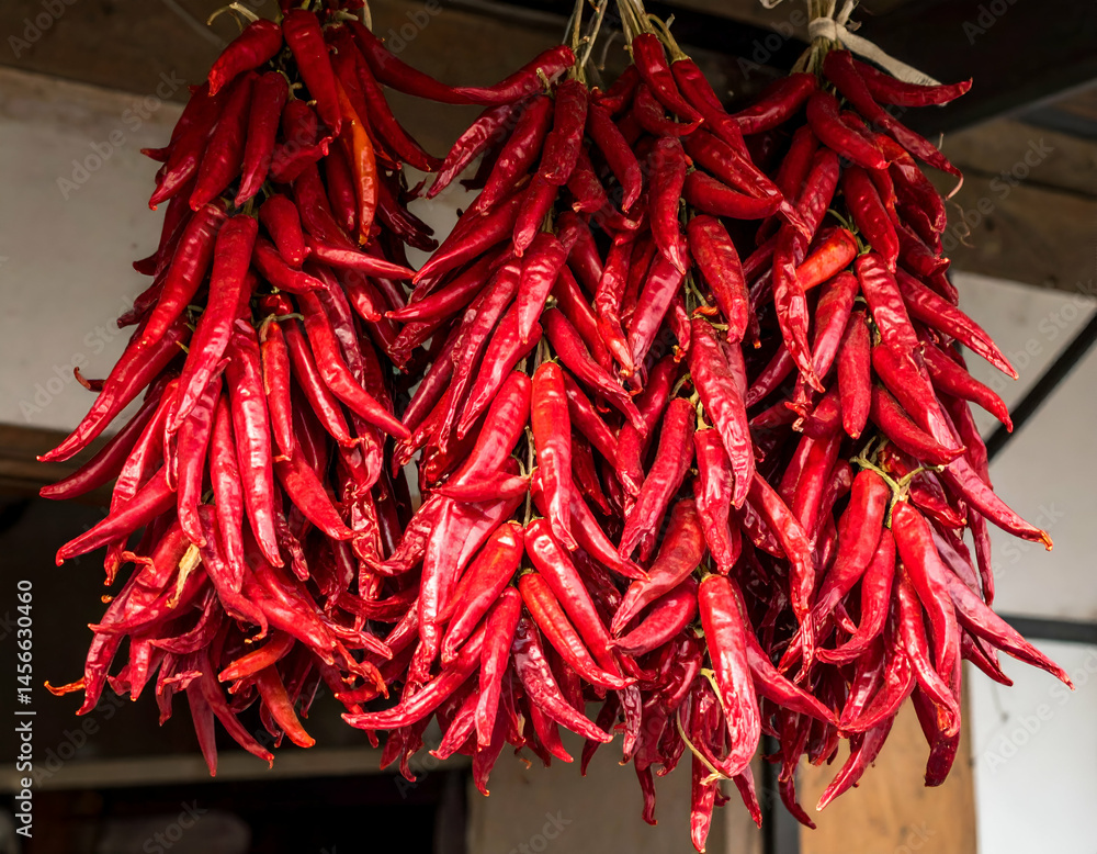 Naklejka premium Dried Red Chili Peppers Hanging For Sale