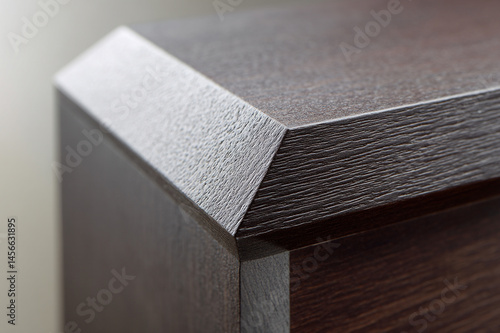 Geometric luxury wood design with plain color, close up of modern furniture corner, textured dark brown surface, minimalistic style, elegant and sophisticated appearance