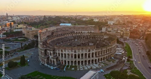 Establishing shot drone flying of the Colosseum. Famous Ancient Roman Arena. Downtown Rome, Italy. The Colosseum and the Imperial Forums in Rome. Beautiful aerial shot with drone around the Colosseum