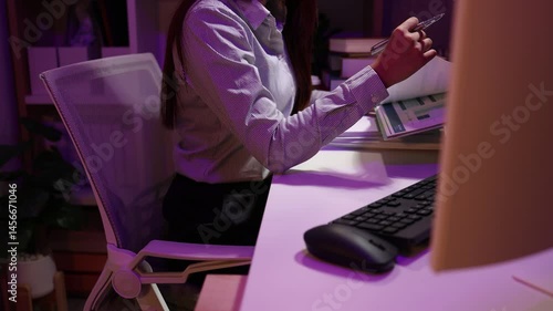 a businesswoman works late into the night because she has to deal with important contract documents that ned to be presented tomorrow, one of the employees worked overtime