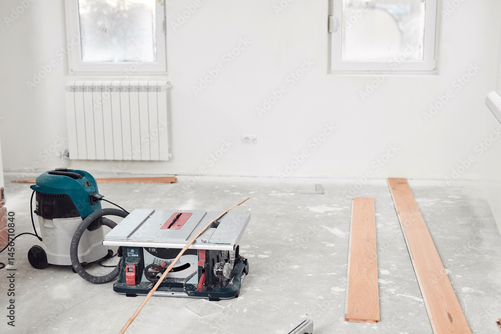 Assembling new laminate hardwood floor.