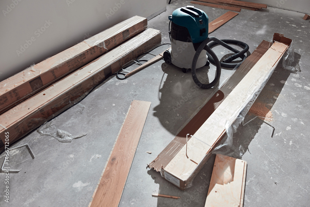 Assembling new laminate hardwood floor.