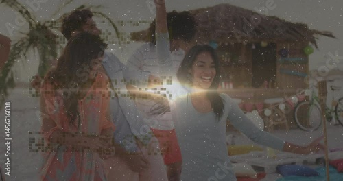 Group dancing around beach picnic table at sunset, showing lantern icons and marketing charts