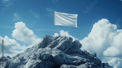 A blank flag waving atop a rocky mountain peak.