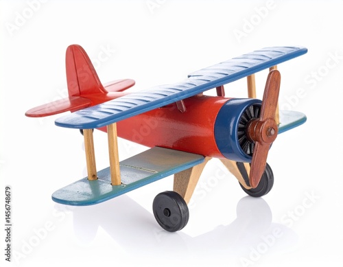 Obraz na płótnie Colorful wooden biplane toy with red, blue, and natural wood elements on a reflective surface w salonie