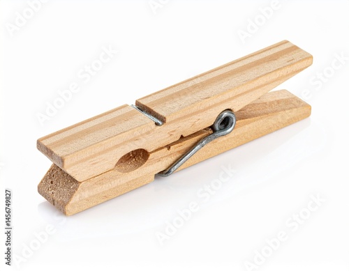 Obraz na płótnie Wooden clothespin featuring a metal spring, showing a simple, functional household object on a white background w salonie