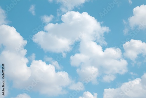 Fluffy white clouds float in a bright blue sky, creating a peaceful and serene atmosphere.