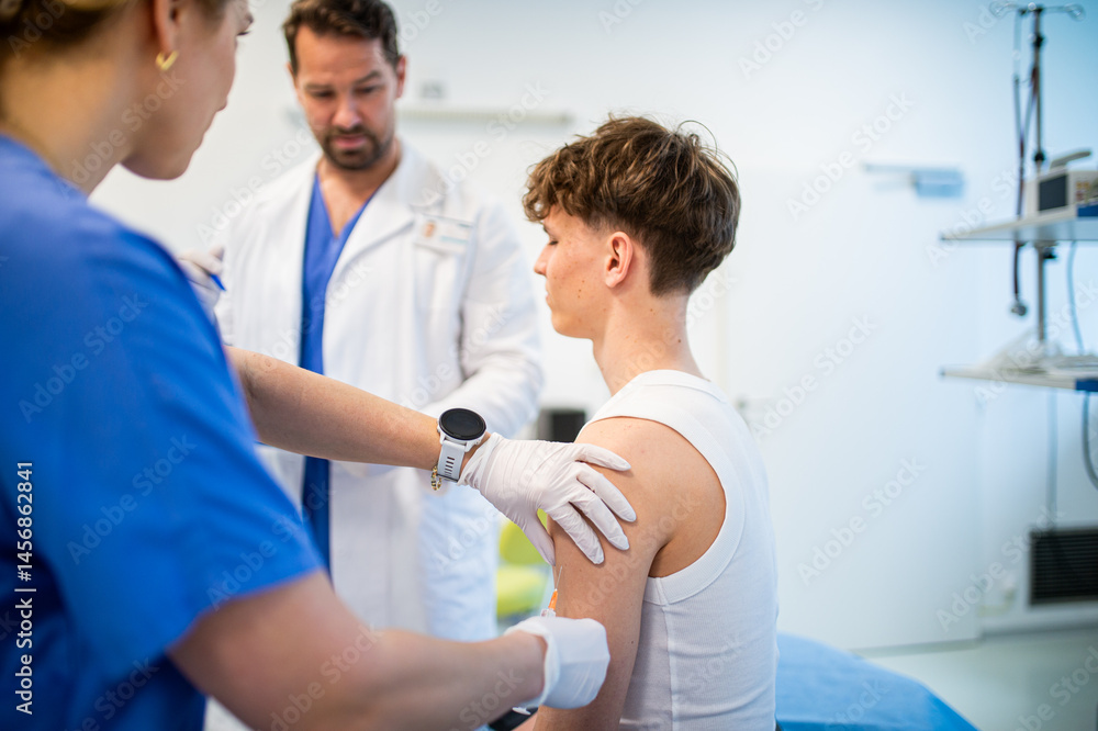 Fototapeta premium Vaccination of teenage boy during routine health checkup at hospital