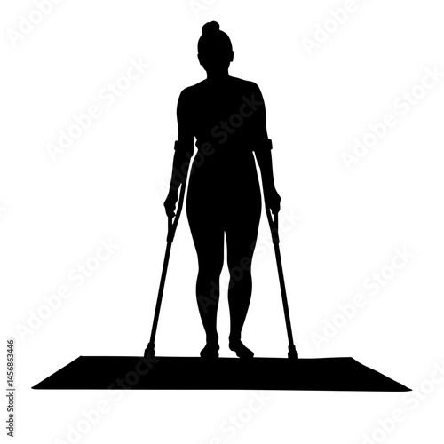 Silhouette of person using crutches on beach mat, adaptive inclusion