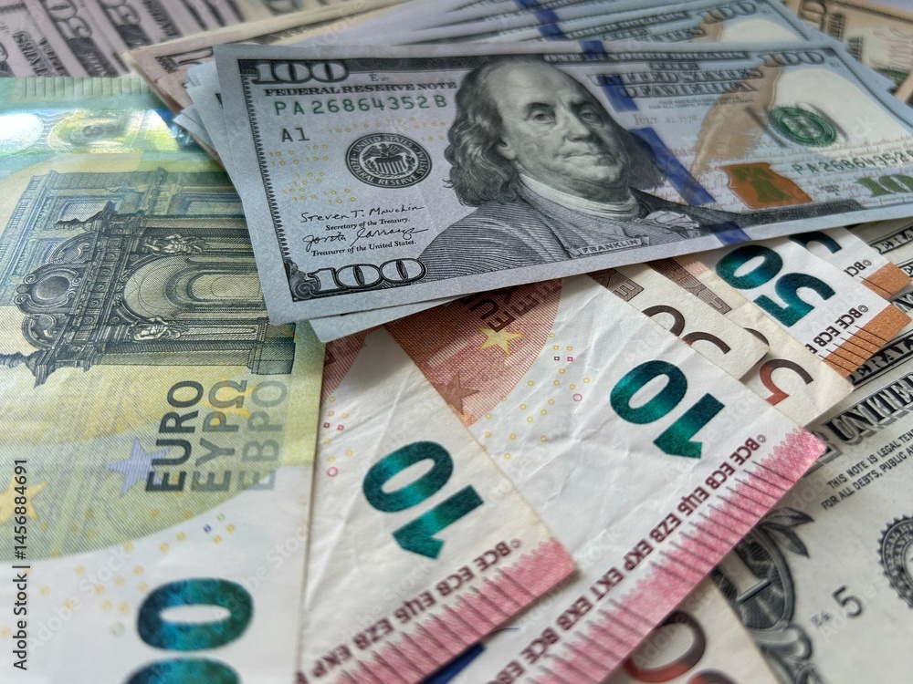 Obraz premium dollar and euro bills. Close-up footage of US dollar and Euro banknotes. Financial concept showing international currency, exchange rates, money circulation, and global economy