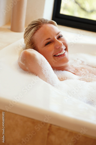Obraz na płótnie Bathroom, happy and portrait of woman in bath with soap, bubbles and foam for cleaning, washing and grooming. Relax, pamper and person in water for calm for skincare, wellness and self care in home w salonie