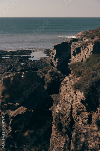 A striking cliff formation rising above the ocean, showcasing the rugged beauty of nature