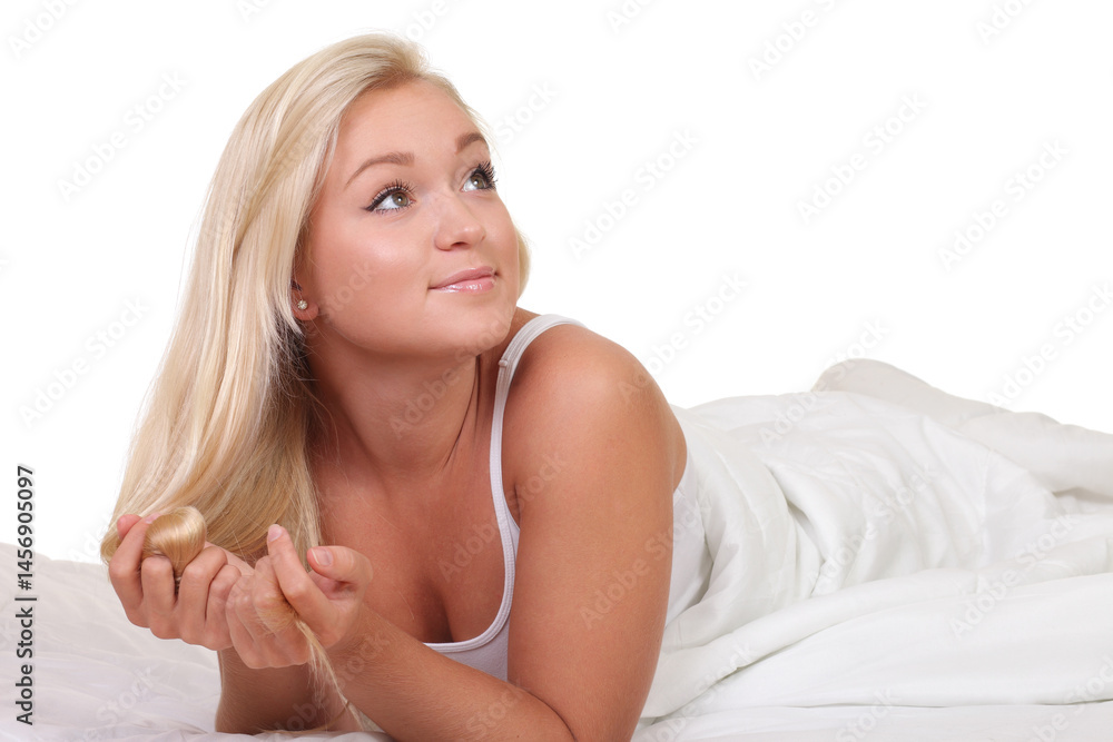 Blonde woman lying in bed under white blanket Blonde woman lying in bed under white blanket