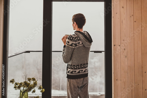 Obraz na płótnie Man Drinking Morning Coffee by Big Window w salonie