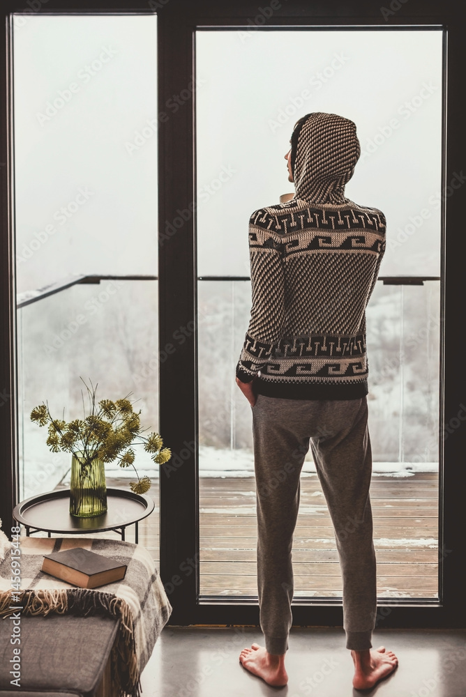 Man Enjoying Winter Scenery outside Window