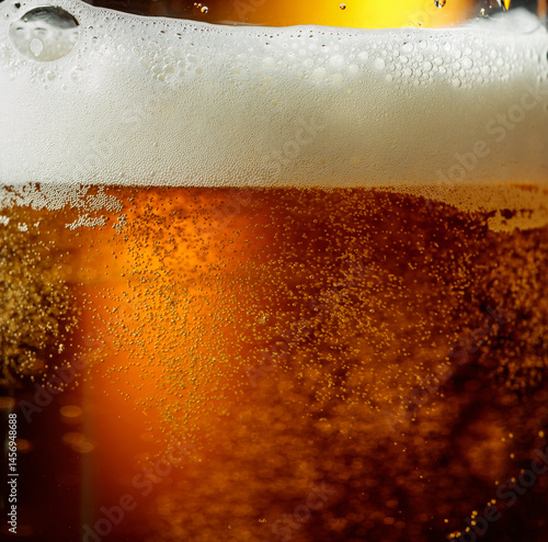 Glass of beer with foam, closeup.