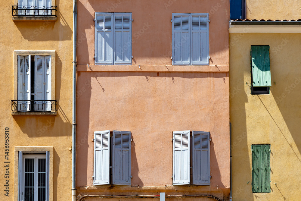 background of colorful old facades with open and closed wooden shutter in Aix en Provence