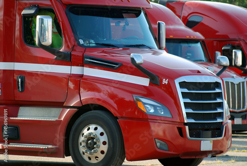 Parked red trucks awaiting dispatch.  Resubmission with
enhancements'