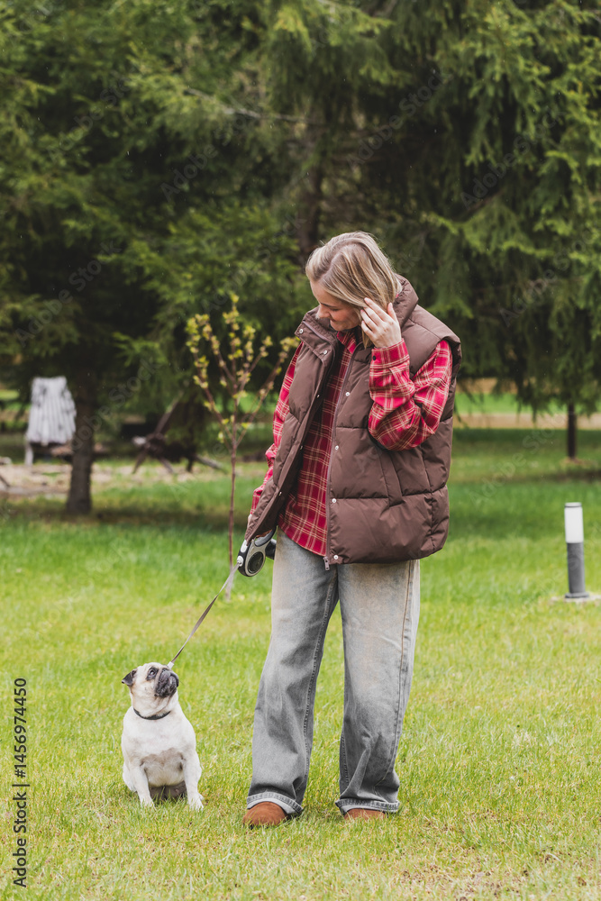 beautiful girl walking with a dog, pug beautiful girl walking with a dog, pug