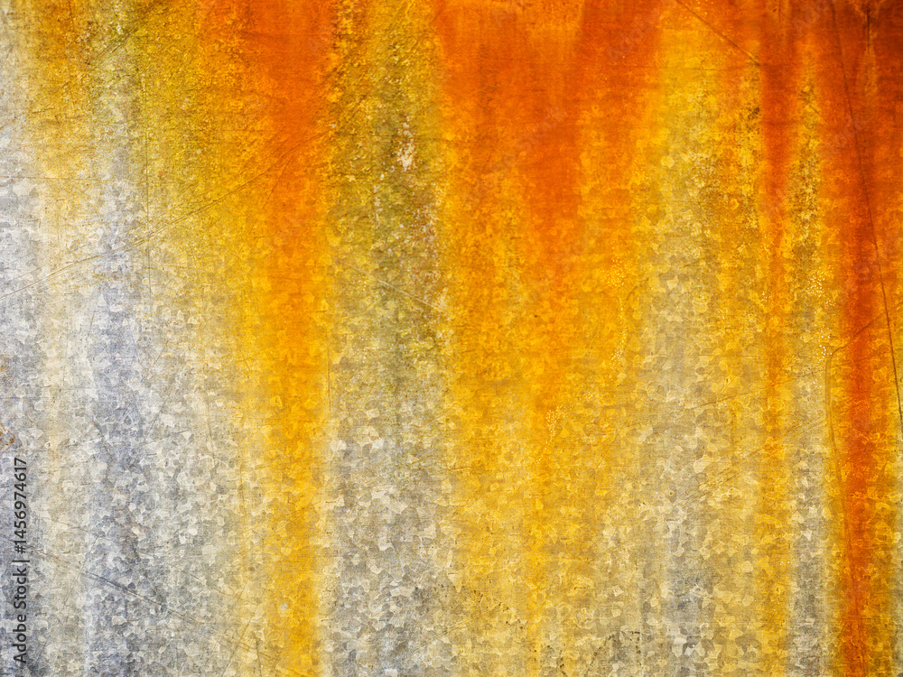 A rusty metal surface with a yellowish-orange hue. The surface appears to be weathered and worn, giving it a sense of age and history