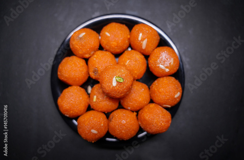 Close up of Indian traditional sweet Laddu served in a black bowl
