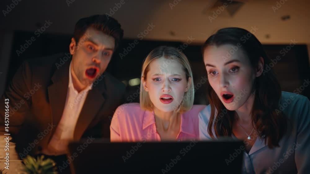 Office managers losing deal shocked on business news laptop late evening closeup Office managers losing deal shocked on business news laptop late evening closeup