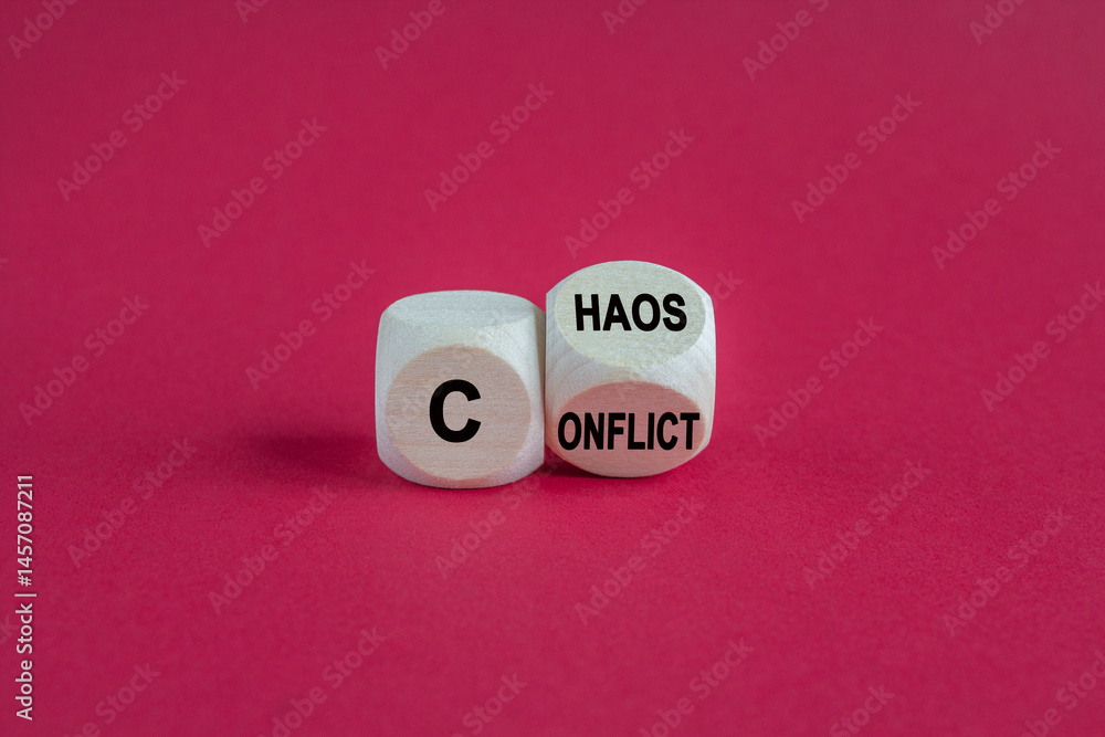 Conflict and chaos symbol. Wooden cubes form the expression from Conflict to Chaos. Beautiful red background. Business Conflict and Chaos concept.