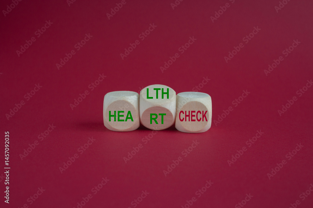 Wooden cubes with the expression 'heart check' and 'health check'. Beautiful pink background. Medical and business concept.