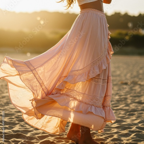 Woman in Flowing Pink Skirt on Sandy Beach at Sunset