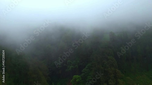 timelapse of fog moving over green hills, with a dramatic feel