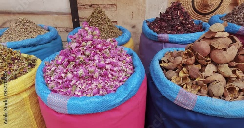 Colorful spice and rose petal display at a traditional Moroccan market