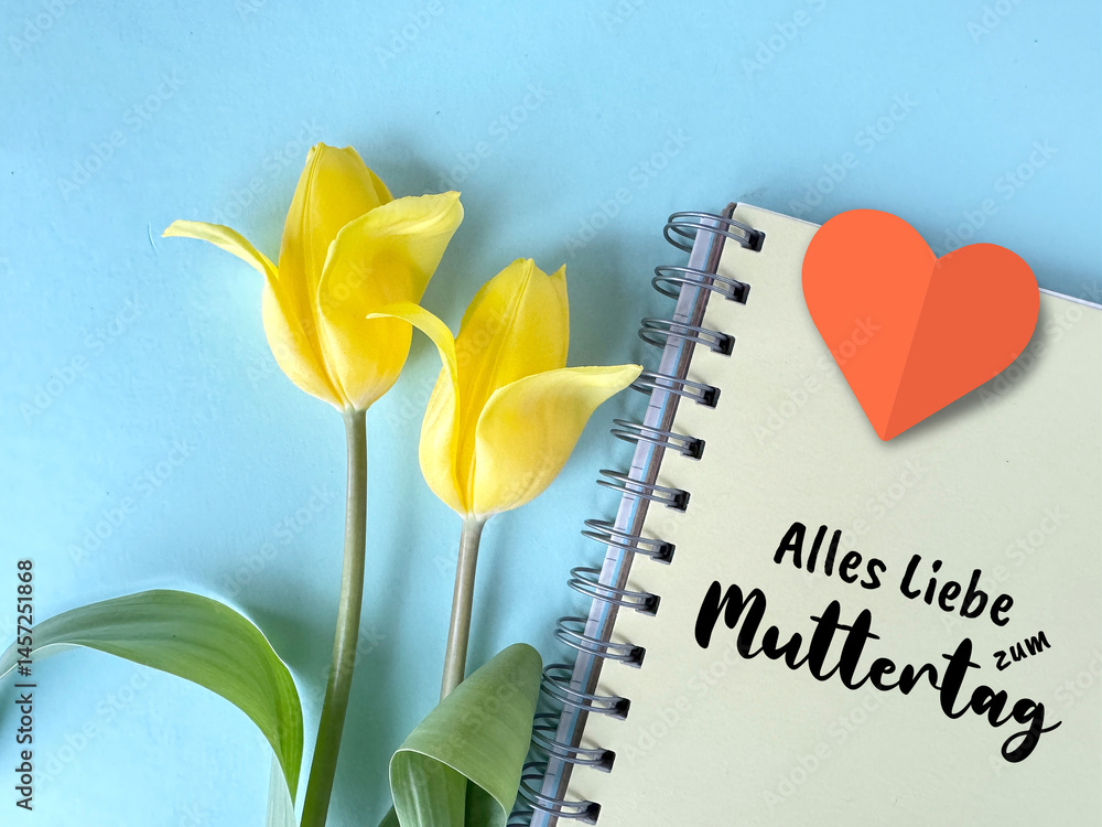 Yellow tulips with notebook featuring text