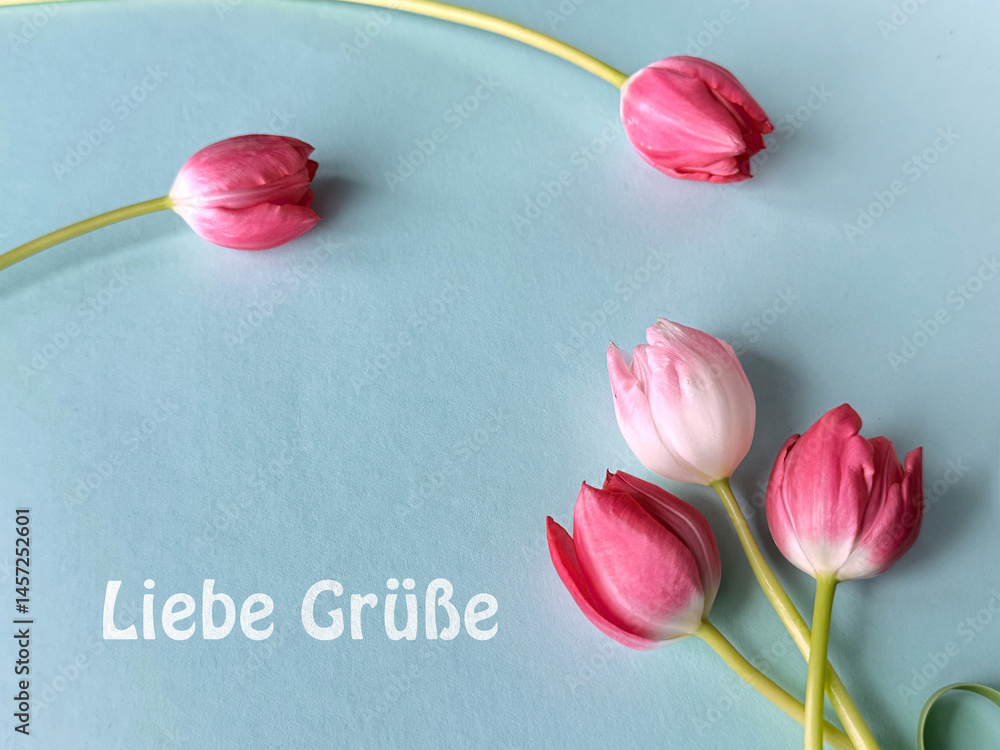 Pink and red tulips on a light blue background with text